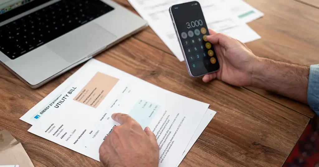 Close-up of a man calculating household utility bills